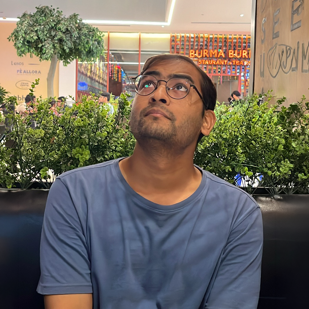Krishna Gilda wearing spectacles and a blue shirt