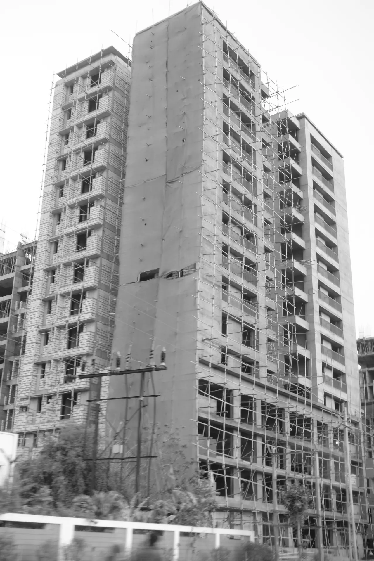 A tall building under construction, photographed vertically