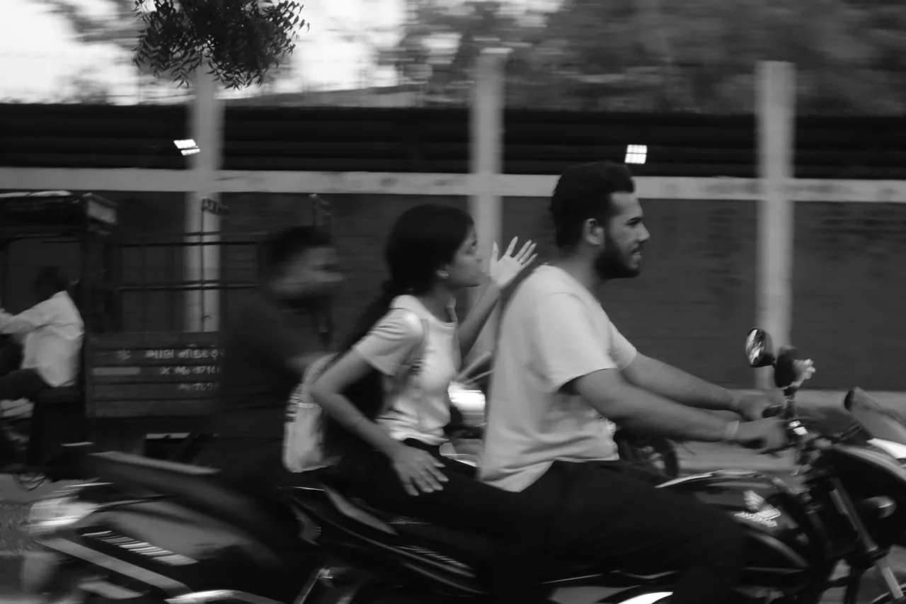 Motorcycle riders passing a blurred streetscape