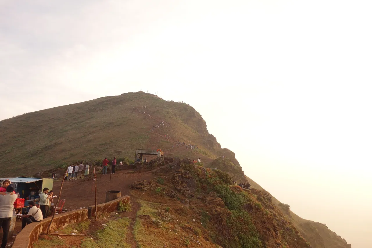 A line of hikers following a narrow mountain ridge