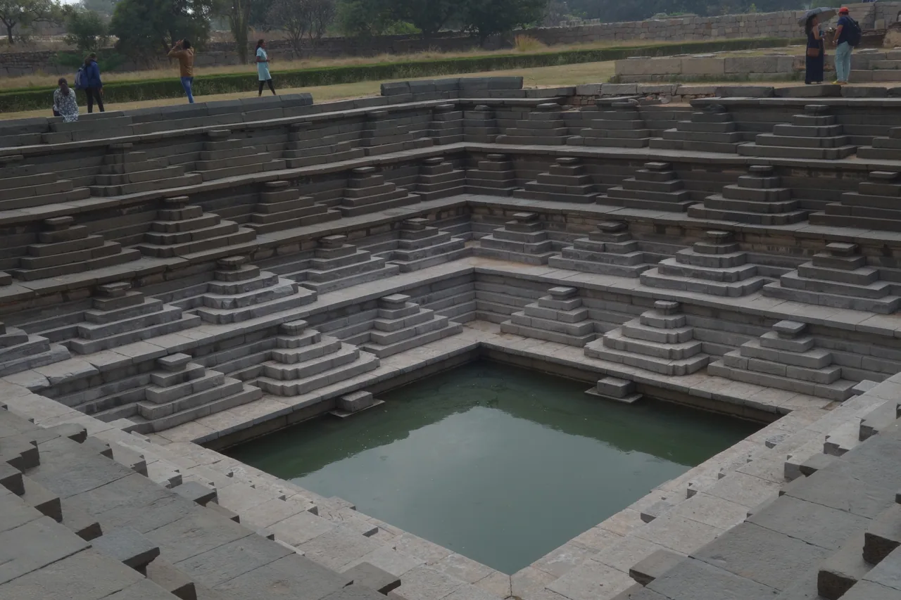 Geometric stone steps descending towards a square pool