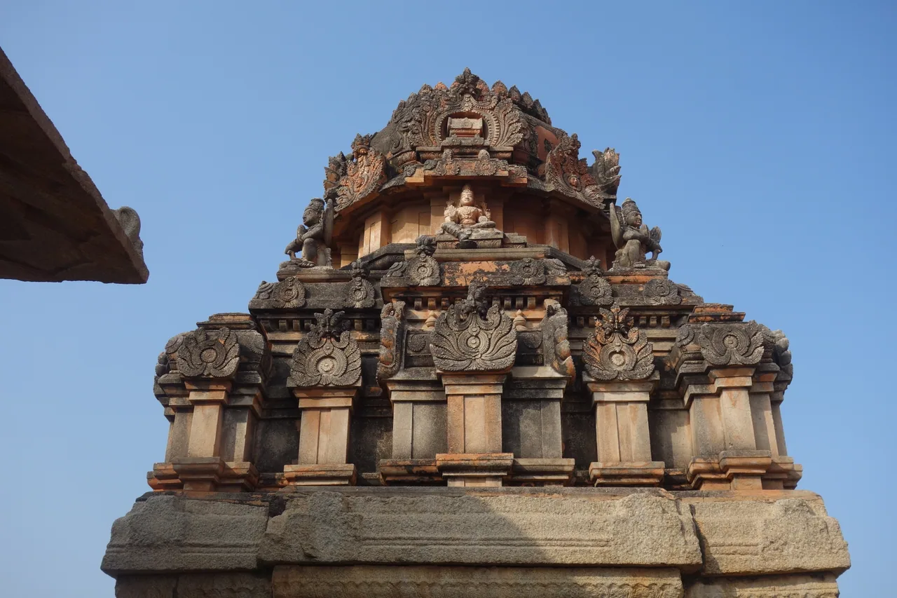 An ornate stone temple tower against a clear sky